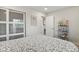 Well-lit bedroom featuring a sliding door closet, and a decorative shelving unit at 7404 La Quinta Ln, Lone Tree, CO 80124