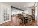 Open concept dining area with hardwood floors and modern lighting adjacent to kitchen at 7404 La Quinta Ln, Lone Tree, CO 80124