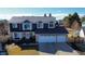 Charming two-story home with a three-car garage and manicured landscaping at 7404 La Quinta Ln, Lone Tree, CO 80124