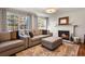 Bright living room with a fireplace, hardwood floors, and large windows for natural light at 7404 La Quinta Ln, Lone Tree, CO 80124