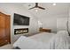 Well-lit main bedroom with a modern fireplace, and TV, offering relaxation and comfort at 7404 La Quinta Ln, Lone Tree, CO 80124