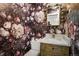 Elegant powder room featuring bold floral wallpaper, marble countertop and designer mirror at 7404 La Quinta Ln, Lone Tree, CO 80124