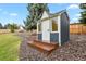 Charming backyard shed with shingle roof, double doors and beautiful paint at 7404 La Quinta Ln, Lone Tree, CO 80124