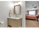 Stylish bathroom featuring updated vanity, modern fixtures, and a peek into the adjacent bedroom at 660 S Alton Way # 10D, Denver, CO 80247