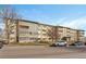 Building exterior featuring a three-story apartment building with ample parking at 660 S Alton Way # 10D, Denver, CO 80247