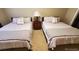 Two twin beds with nightstands and lamps at 660 S Alton Way # 10D, Denver, CO 80247