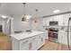 Modern kitchen with white cabinets, stainless steel appliances, and an island at 660 S Alton Way # 10D, Denver, CO 80247