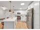Modern kitchen with white cabinets, stainless steel appliances, and an island at 660 S Alton Way # 10D, Denver, CO 80247