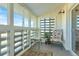 Enclosed sun room with multiple windows, a patterned rug, and comfortable seating providing a cozy retreat at 660 S Alton Way # 10D, Denver, CO 80247