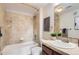 Cozy bathroom features a shower and tub, and a stylish vanity with granite counters at 9019 E Panorama Cir # D504, Englewood, CO 80112