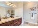 Bathroom featuring double sink vanity, large mirror, and neutral decor at 9019 E Panorama Cir # D504, Englewood, CO 80112