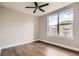 Bright bedroom features a ceiling fan, neutral paint, and beautiful hardwood floors at 9019 E Panorama Cir # D504, Englewood, CO 80112