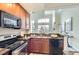 Modern kitchen with granite counters, stainless steel appliances, and open floor plan at 9019 E Panorama Cir # D504, Englewood, CO 80112