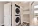 Convenient laundry closet with stacked washer and dryer, and extra shelving space at 9019 E Panorama Cir # D504, Englewood, CO 80112