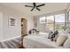 Inviting main bedroom featuring ample natural light, ceiling fan, and wood-look flooring at 9019 E Panorama Cir # D504, Englewood, CO 80112