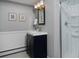 Bathroom with navy vanity, mirror, and glass enclosed shower at 3580 Broadway St # 3, Boulder, CO 80304