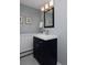 Bathroom featuring a navy vanity, large mirror and modern lighting at 3580 Broadway St # 3, Boulder, CO 80304