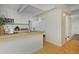 Bright kitchen features white cabinets and appliances, breakfast bar, and wood flooring at 3580 Broadway St # 3, Boulder, CO 80304