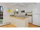 Bright kitchen features white cabinets, a breakfast bar, and a view to the outside at 3580 Broadway St # 3, Boulder, CO 80304