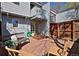 Private brick patio with seating, plants, and a wooden fence, offering a relaxing outdoor space at 3580 Broadway St # 3, Boulder, CO 80304