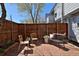 Charming brick patio with wood fence, seating, and planter creating a cozy outdoor space at 3580 Broadway St # 3, Boulder, CO 80304
