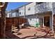 Inviting patio with brick pavers, white siding, wooden privacy fence, and outdoor seating near the entrance at 3580 Broadway St # 3, Boulder, CO 80304