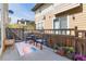 Charming backyard patio featuring a round table with seating, a decorative rug, and a stained wood privacy fence at 3412 Valentia St, Denver, CO 80238