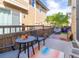 Cozy backyard patio with comfortable seating, a wooden privacy fence, and an area rug, perfect for relaxation at 3412 Valentia St, Denver, CO 80238