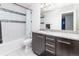 Bathroom with granite countertops, a decorative-tile backsplash, and modern lighting fixtures over a large vanity mirror at 3412 Valentia St, Denver, CO 80238