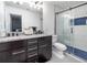 Bathroom featuring double sinks and a glass-enclosed shower at 3412 Valentia St, Denver, CO 80238