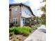 Attractive townhome showcasing stone pillars and detailed landscaping, framed by a paved walkway and lush greenery at 3412 Valentia St, Denver, CO 80238