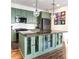Open kitchen with an island, granite countertops and modern lighting at 3412 Valentia St, Denver, CO 80238