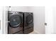 Modern laundry room with high-efficiency washer and dryer set, designed for convenient and stylish home care at 3412 Valentia St, Denver, CO 80238