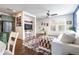 Bright living room features hardwood floors, large windows, and a cozy white sofa at 3412 Valentia St, Denver, CO 80238