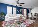 Comfortable living room boasts hardwood floors, a plush white sofa, and bright natural light at 3412 Valentia St, Denver, CO 80238