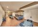 Spacious finished basement with hardwood floors, multiple seating areas, and a foosball table at 106 Cherry St, Castle Rock, CO 80104