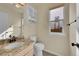 Bright bathroom featuring a granite vanity, medicine cabinet and tile floor at 106 Cherry St, Castle Rock, CO 80104