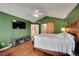 Bedroom features hardwood floors and a sliding barn door to the ensuite bathroom at 106 Cherry St, Castle Rock, CO 80104