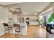 Open kitchen with stainless steel appliances, granite countertops, a breakfast bar, and hardwood floors at 106 Cherry St, Castle Rock, CO 80104