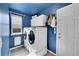 Functional laundry room with front-loading washer/dryer, cabinetry, and a window for natural light at 106 Cherry St, Castle Rock, CO 80104
