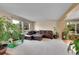 Comfortable living room with a leather sectional sofa, large windows, and plants at 106 Cherry St, Castle Rock, CO 80104