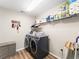 Convenient laundry room with washer, dryer, and storage shelves at 12571 Canoe St, Firestone, CO 80504