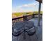 Outdoor living space on back deck with black metal table and furniture and beautiful views at 6958 Brentwood Ct, Arvada, CO 80004