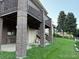 Spacious backyard with covered patio, brick support beams, and mature trees at 6958 Brentwood Ct, Arvada, CO 80004