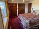 Bedroom featuring natural light from window, dark wood accents, and multiple closets at 6958 Brentwood Ct, Arvada, CO 80004