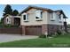 Charming exterior elevation featuring brick accents, bay windows, and a well-maintained lawn at 6958 Brentwood Ct, Arvada, CO 80004