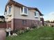 Exterior view showcasing well-maintained lawn, brick accents, and bay windows at 6958 Brentwood Ct, Arvada, CO 80004