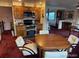 Spacious kitchen with cherry wood cabinets and stainless-steel appliances adjacent to dining area at 6958 Brentwood Ct, Arvada, CO 80004