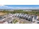 An aerial showcases modern townhomes with a neighborhood street and the area's landscape at 12374 Farmview St, Thornton, CO 80241