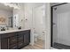 Modern bathroom with a double sink vanity, a separate toilet room, and a glass-enclosed shower at 12374 Farmview St, Thornton, CO 80241